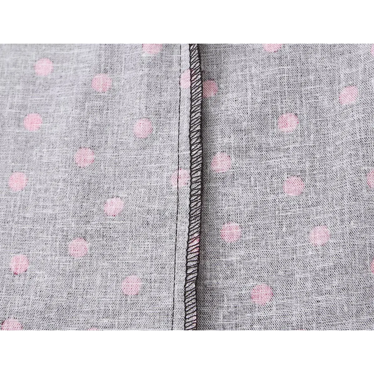 Close-up of the dress's inner lining, showing the polka dot print and overlocked seam finish.