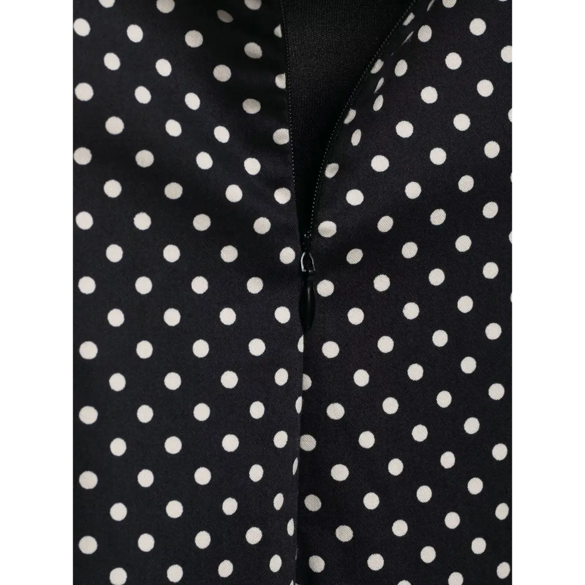 Close-up of the invisible back zipper on the black polka dot cami dress
