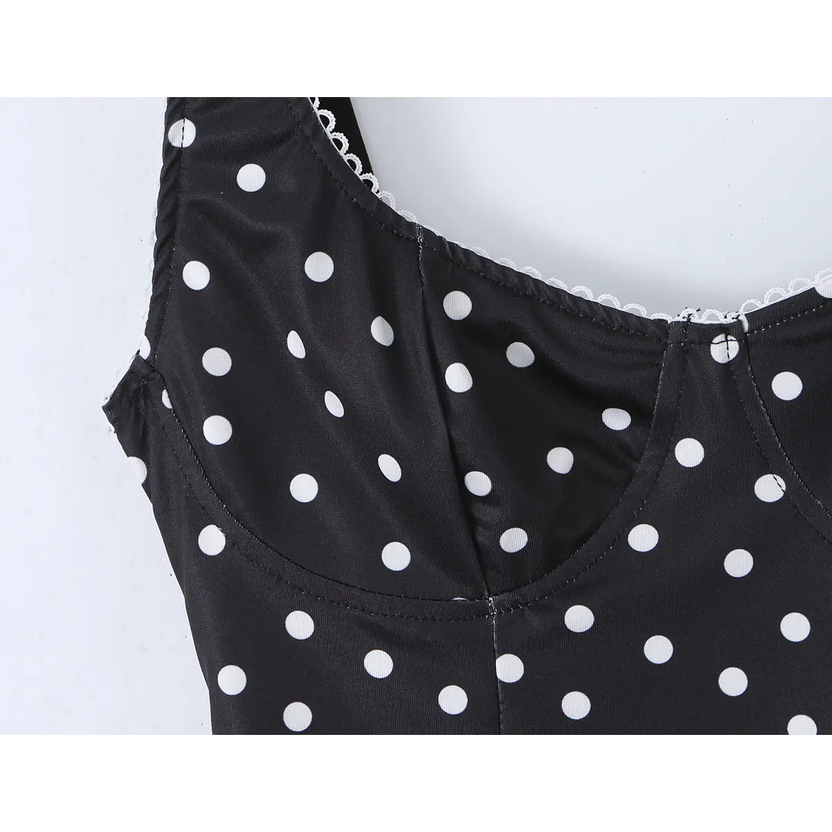 Close-up of the sweetheart neckline and bust cups on the black polka dot cami top