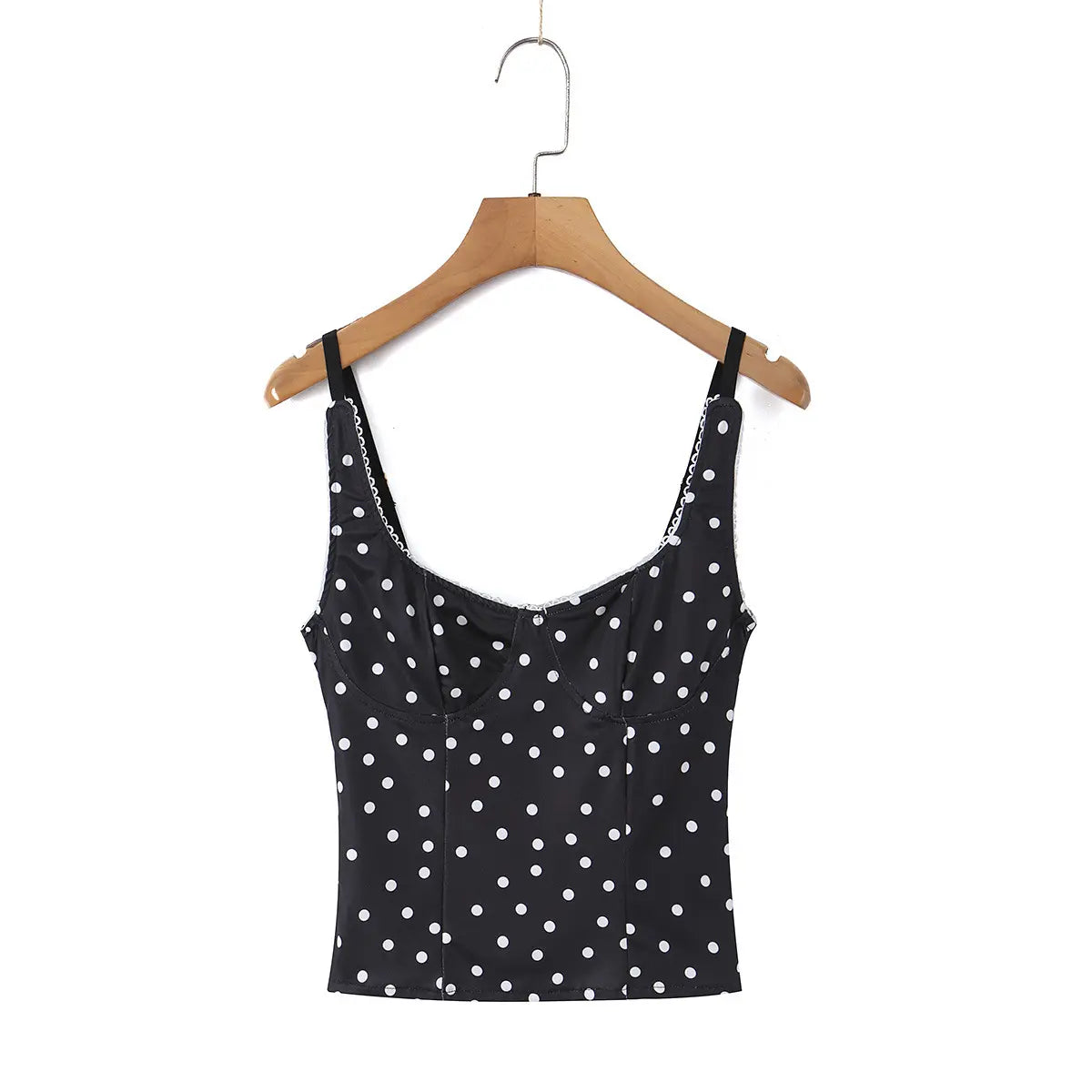 Black polka dot cami top hanging on wooden hanger, full back view