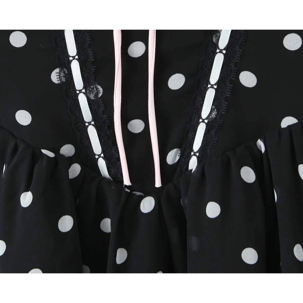 Close-up of the bodice, featuring the keyhole cutout, black lace trim, and pink drawstring ties.