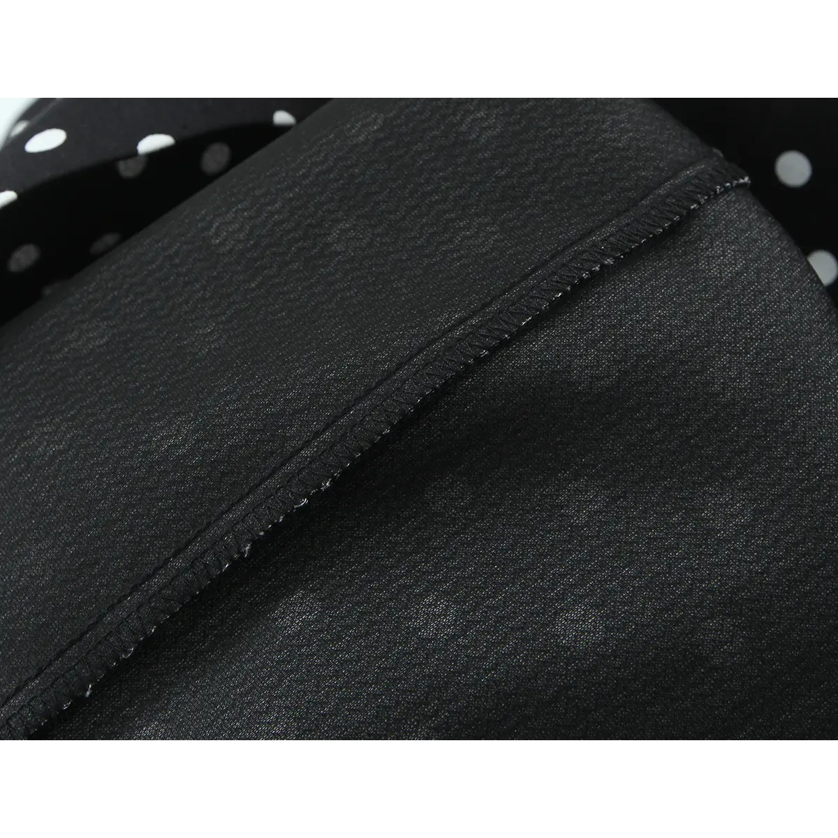 Close-up of the dress's black inner lining, showcasing its smooth texture and finished stitching.
