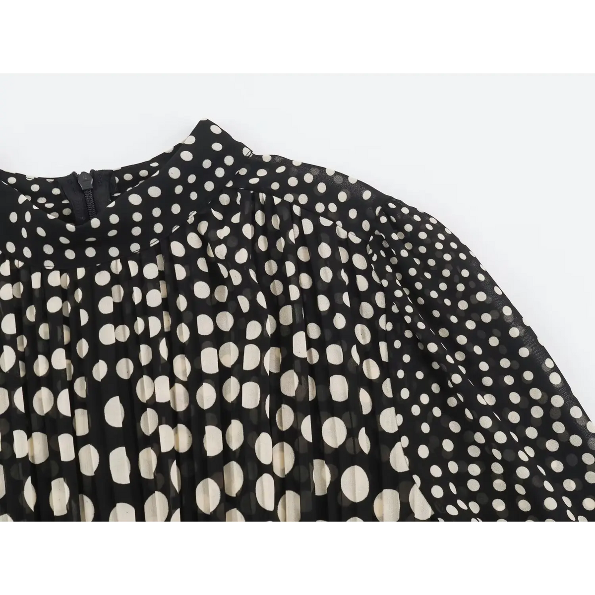 Close-up of chest pleats and soft gathered fabric on black white polka dot maxi dress