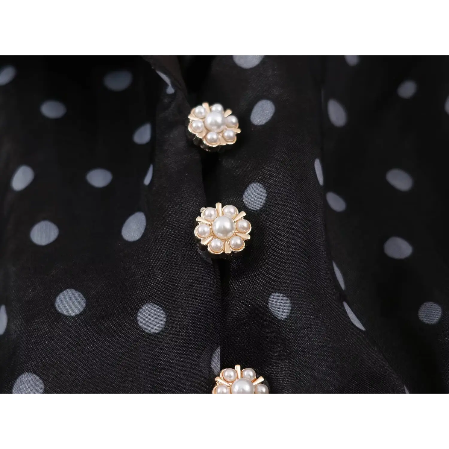 Macro close‑up floral pearl decorative buttons on black polka dot organza maxi dress