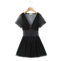 Black polka dot mesh mini dress on wooden hanger, v‑neck short sleeve sheer mesh dress with red rose front detail