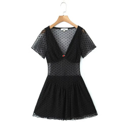 Black polka dot mesh mini dress on wooden hanger, v‑neck short sleeve sheer mesh dress with red rose front detail