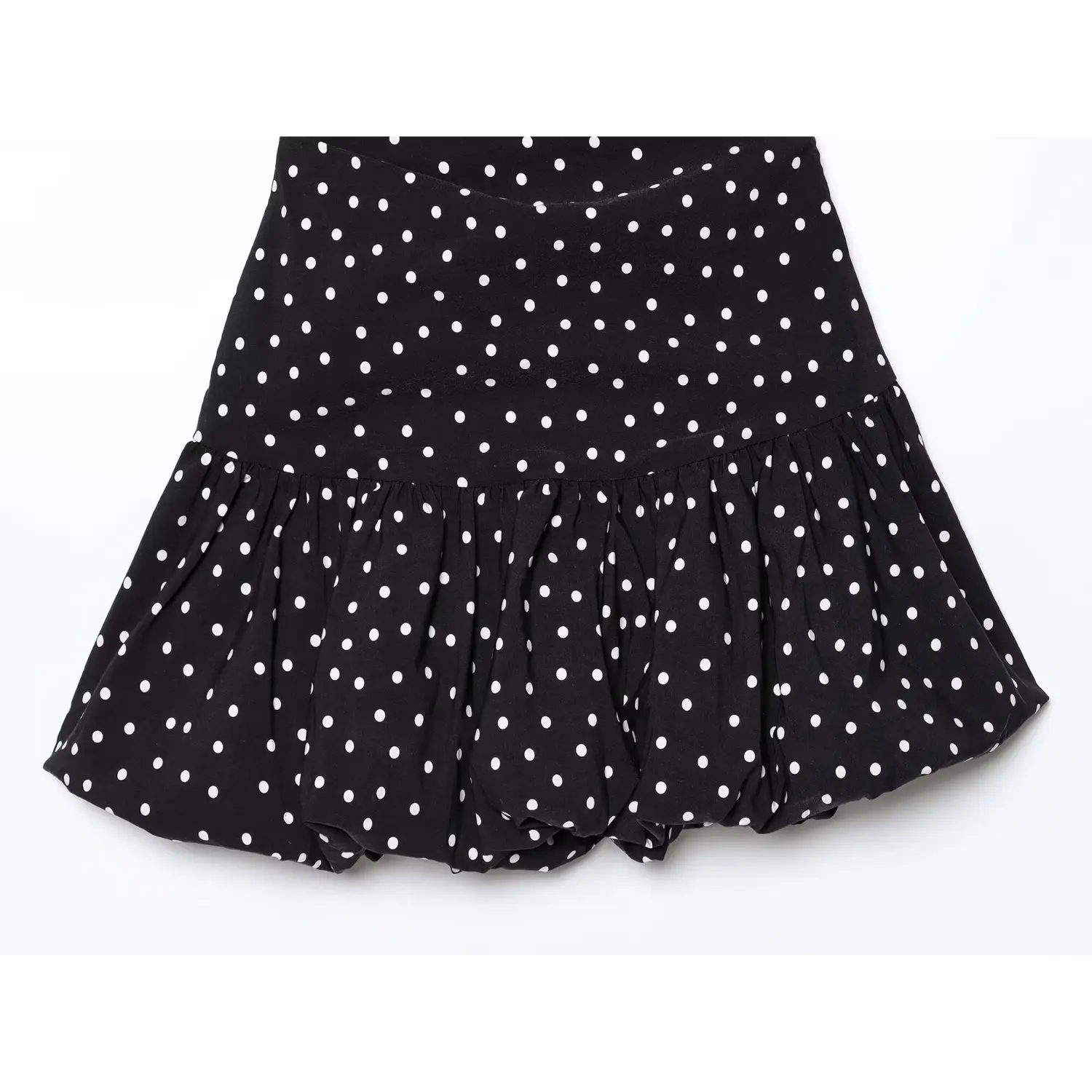 Flat lay full skirt view black polka dot one‑shoulder mini dress gathered ruffle hem