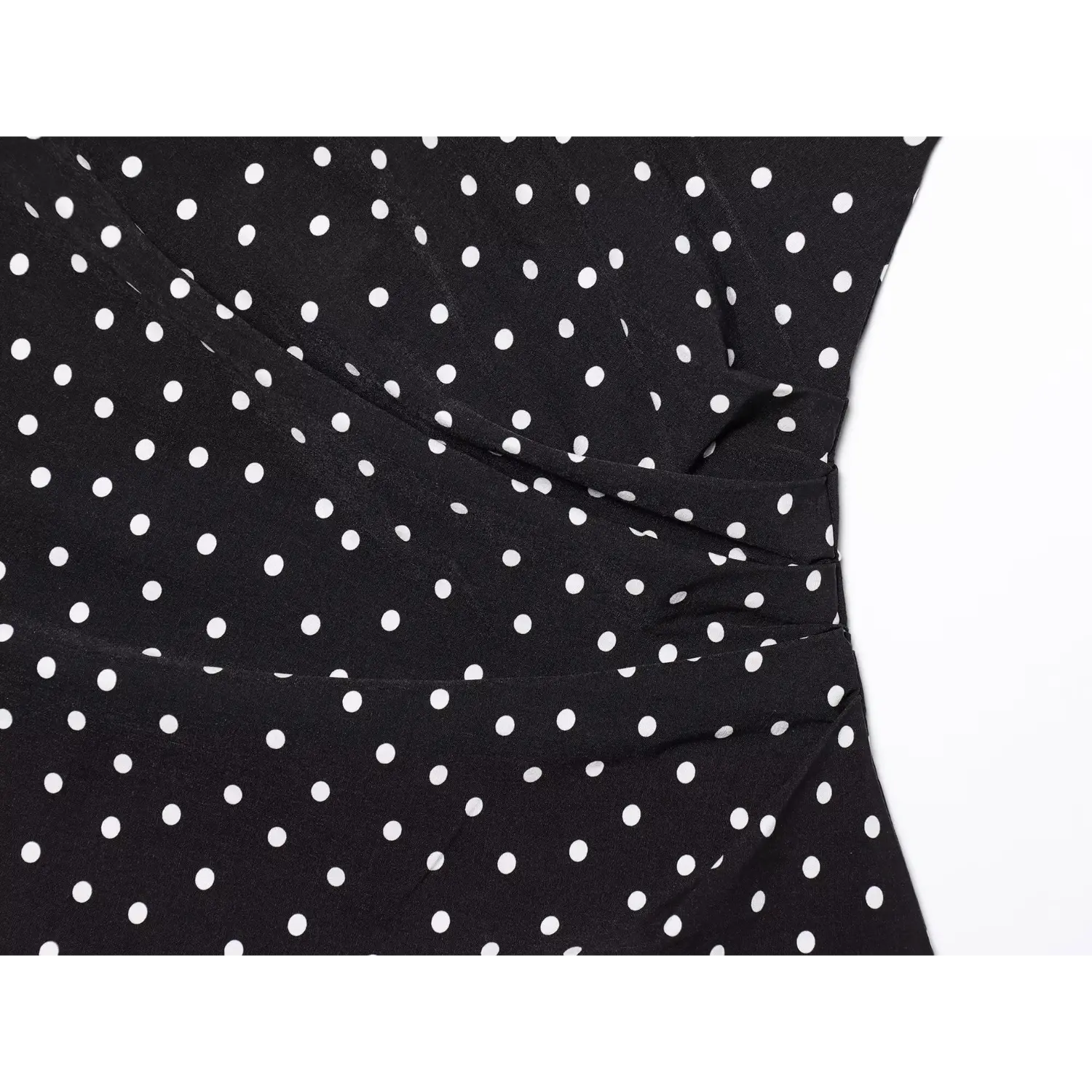 Extreme close‑up wrap bust ruched detail black dress with all over white polka dots