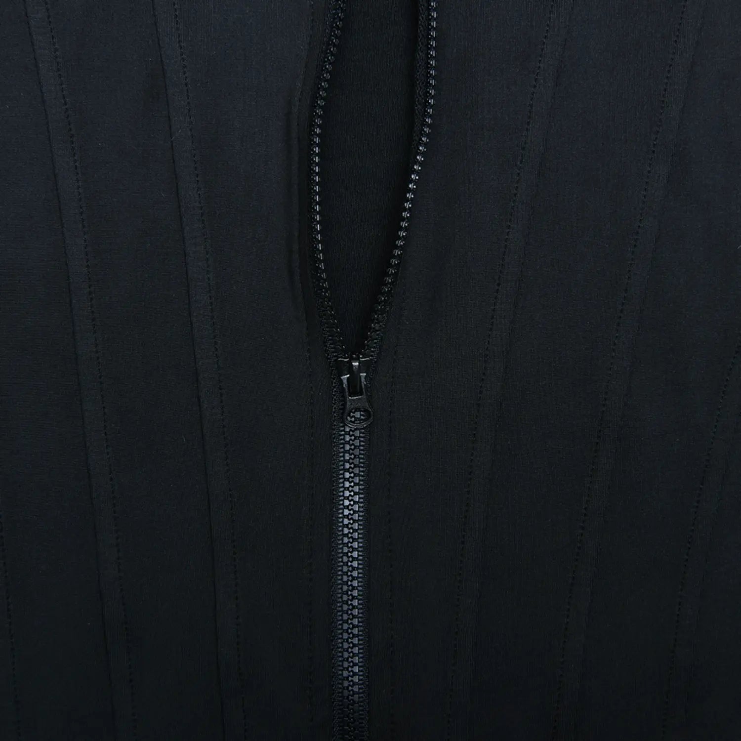 Close‑up view twisted wrap ruched skirt knot and fabric drape detail of black mini dress
