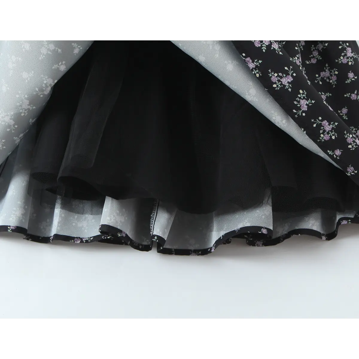 Hem close of floral dress with inner tulle lining and printed edge trim