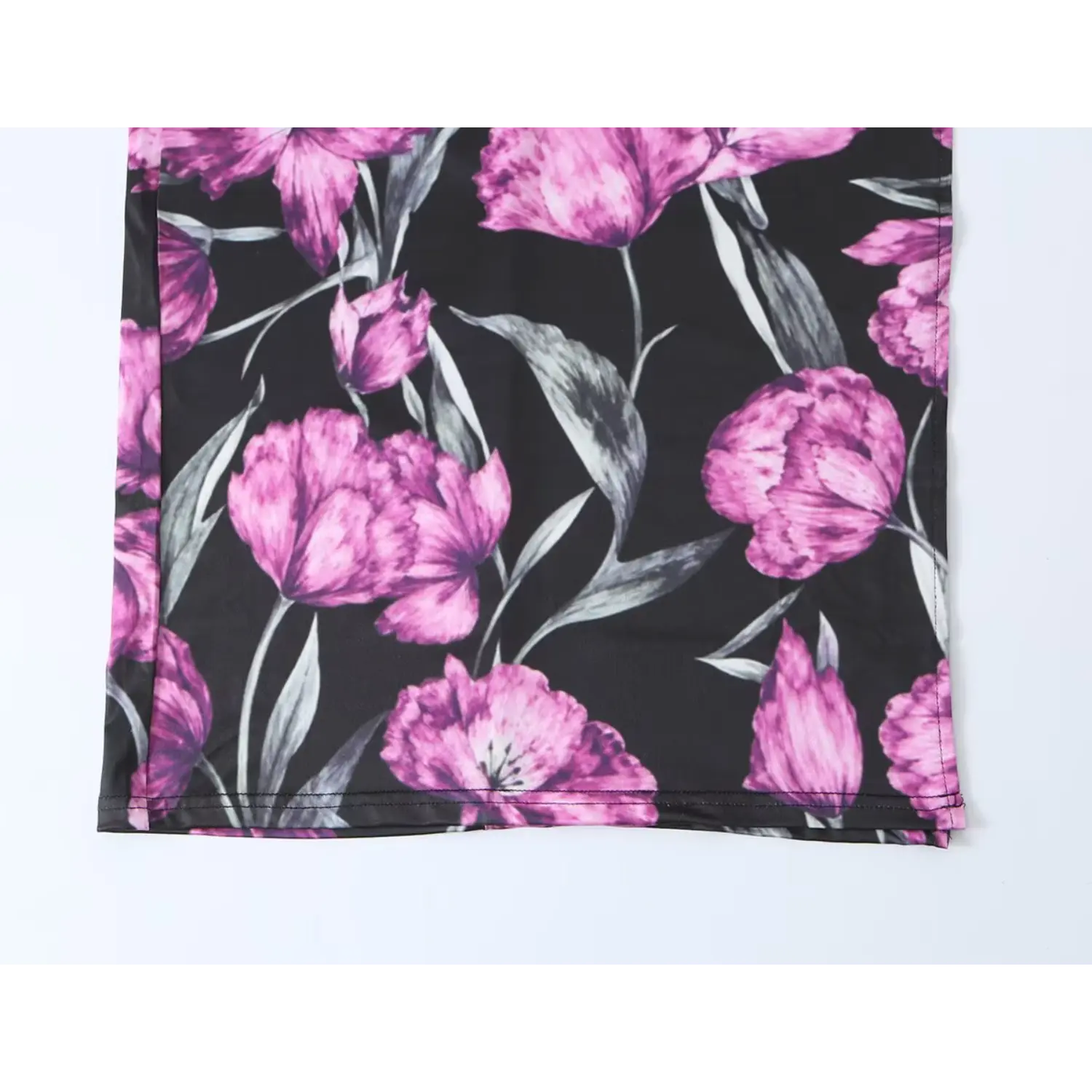 Black maxi dress with purple floral print, close‑up hem detail shot