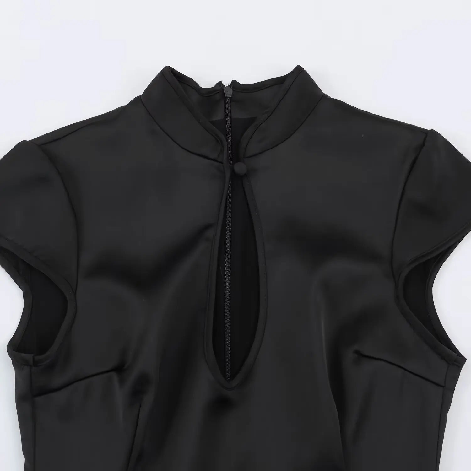 Front neckline macro shot, mandarin stand collar, single fabric frog button, vertical hollow chest keyhole cutout