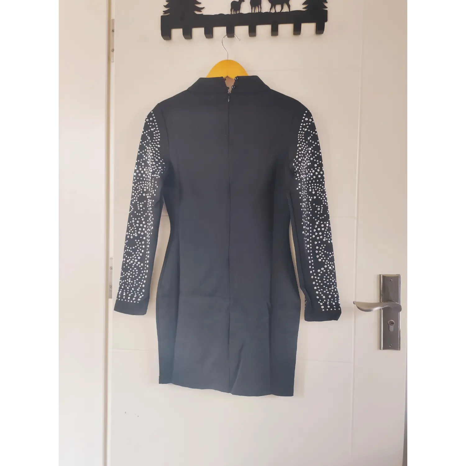 Full hanging back view, black stand collar long sleeve bodycon mini dress with rhinestone sleeves