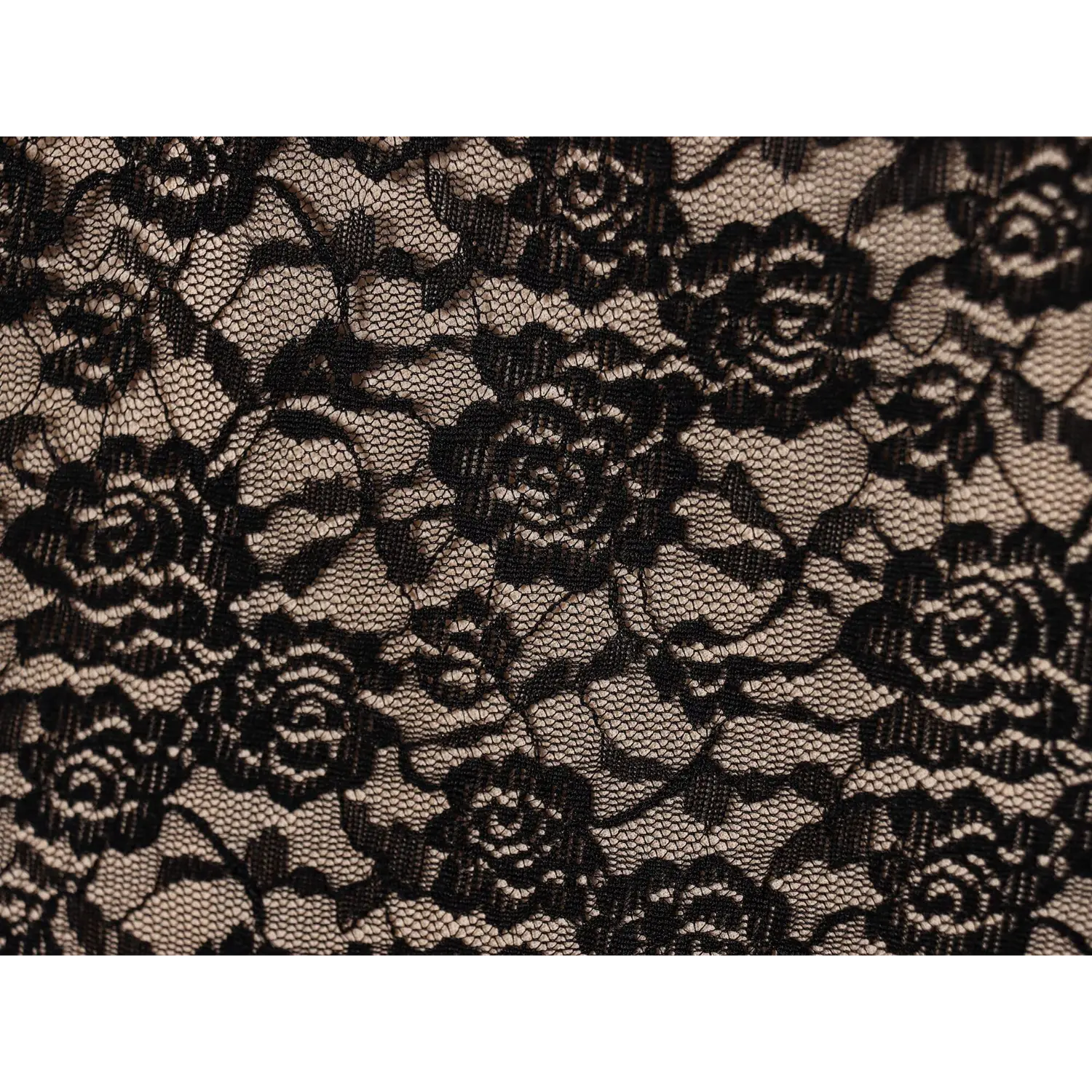 Macro fabric close‑up black rose floral lace pattern over nude lining