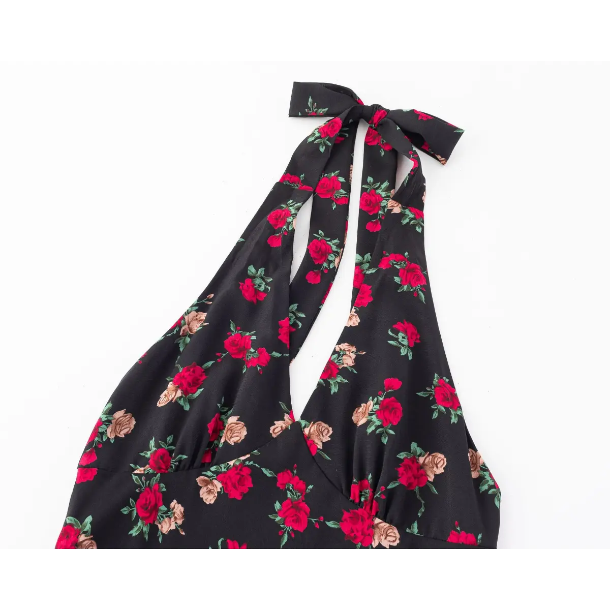 Close-up front view of the halter neckline and tie detail on the black rose print dress.
