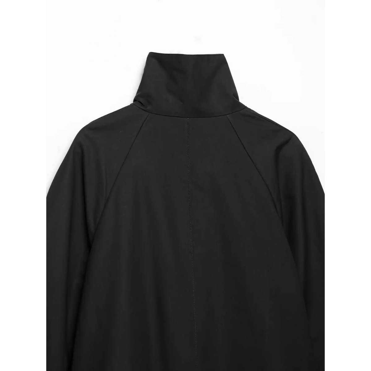 Back upper detail of black cropped jacket, stand high collar and center raglan stitching
