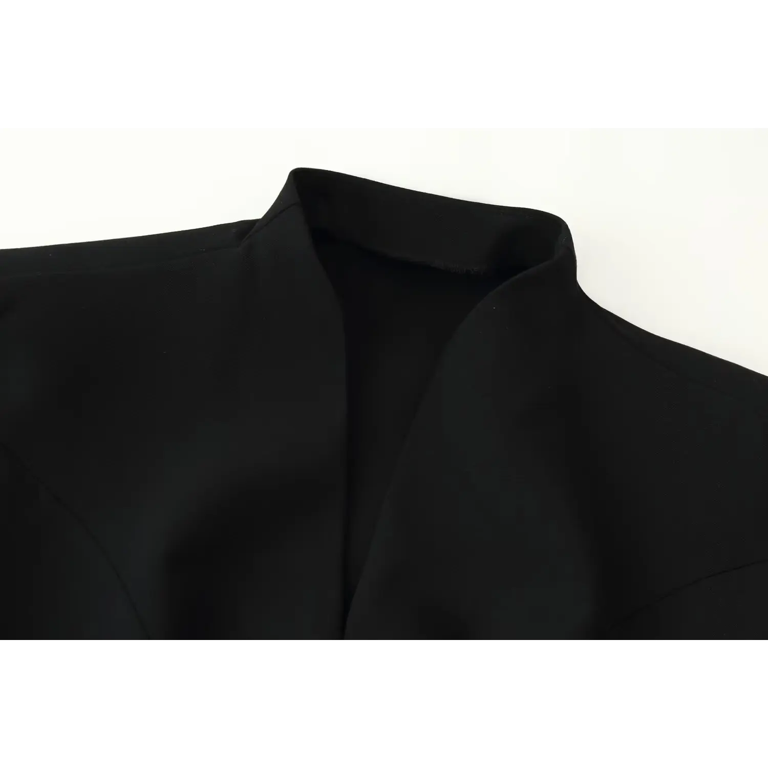 Close‑up detail of stand split neck collar on black sleeveless mini dress