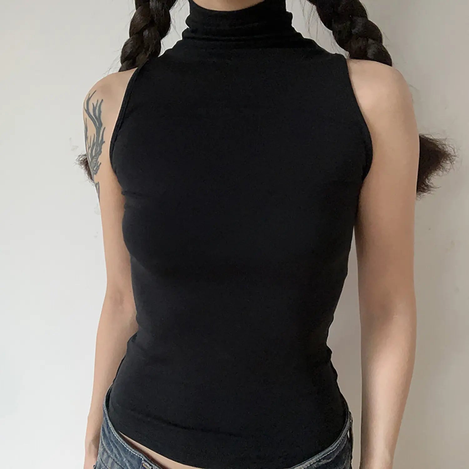Front torso model shot, black sleeveless turtleneck tank top, stretch knit fabric
