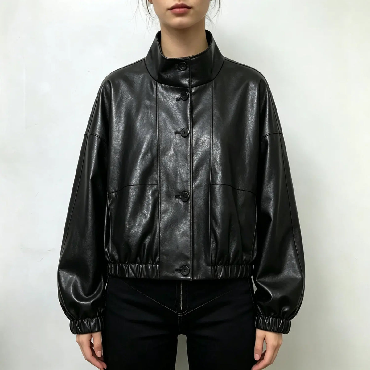 Model wearing black stand collar cropped PU jacket with black trousers