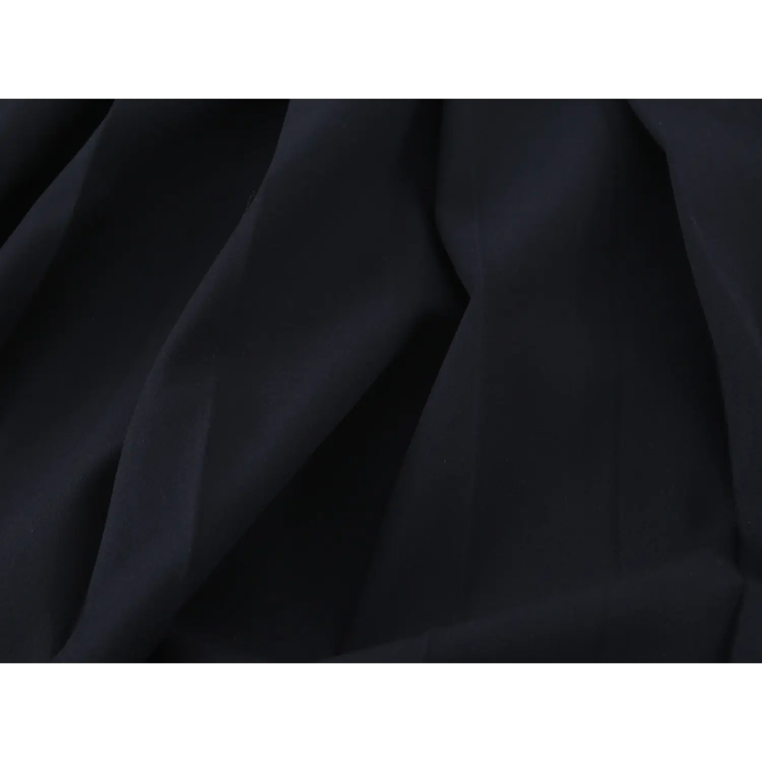 Fabric drape macro shot, dense matte woven suiting, stiff wrinkle-free texture, solid black non-sheer finish