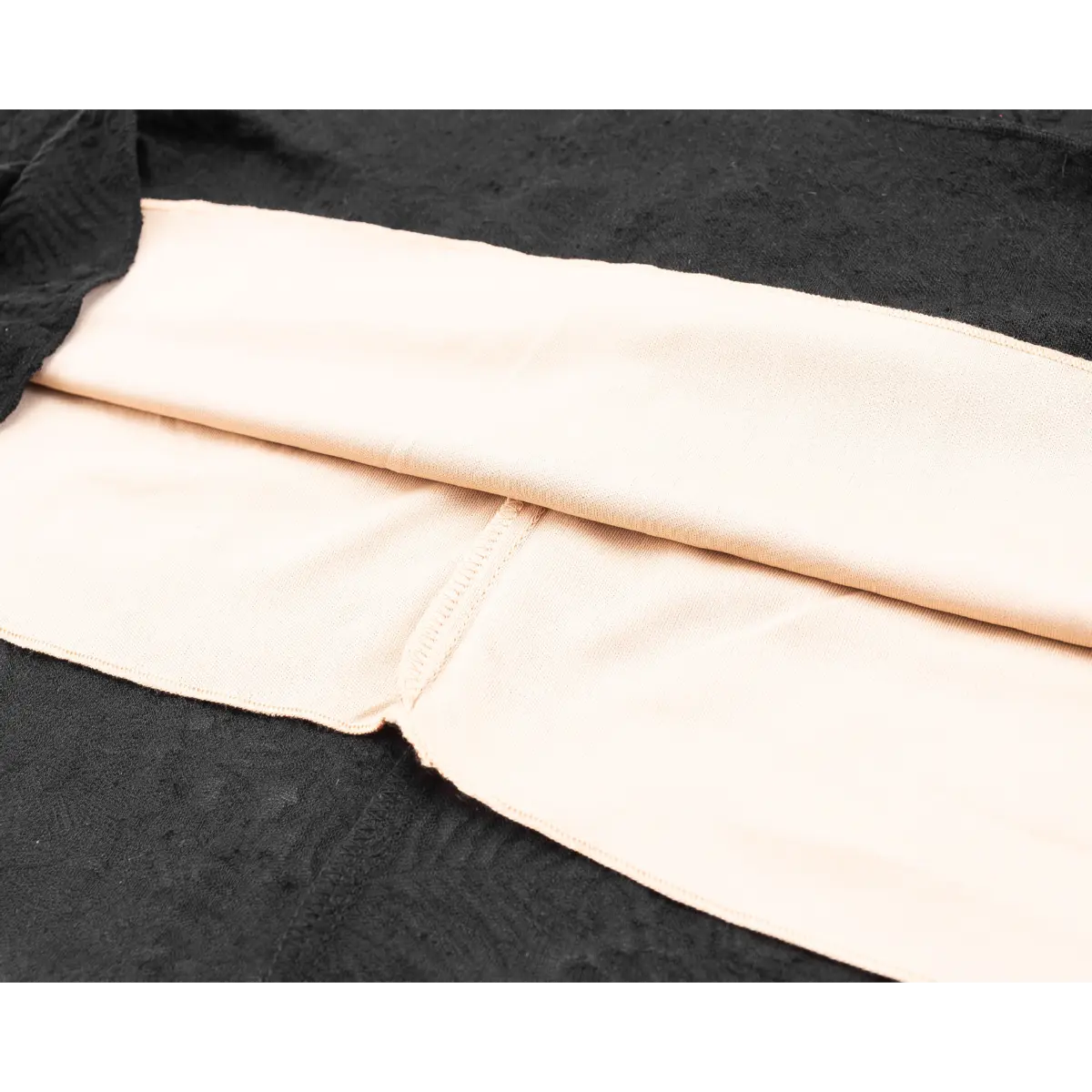 Close-up of the nude-colored lining, showing the smooth fabric and finished seams.