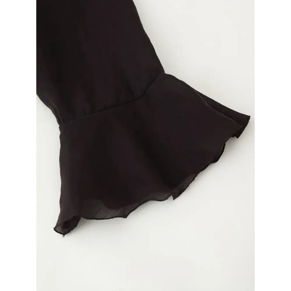 Close-up of flared ruffle long sleeve cuff