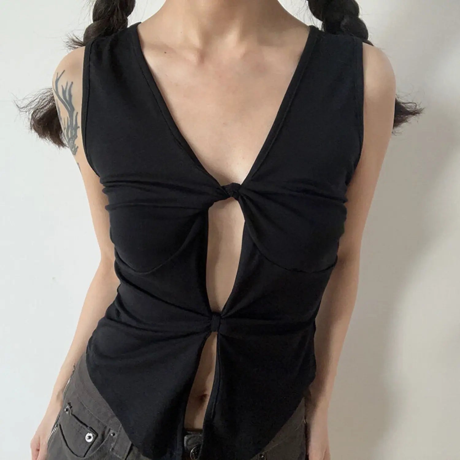 Black double twist cutout sleeveless tank half body indoor shot, stretch knit slim cropped uneven hem cool feminine daily layering inner camisole