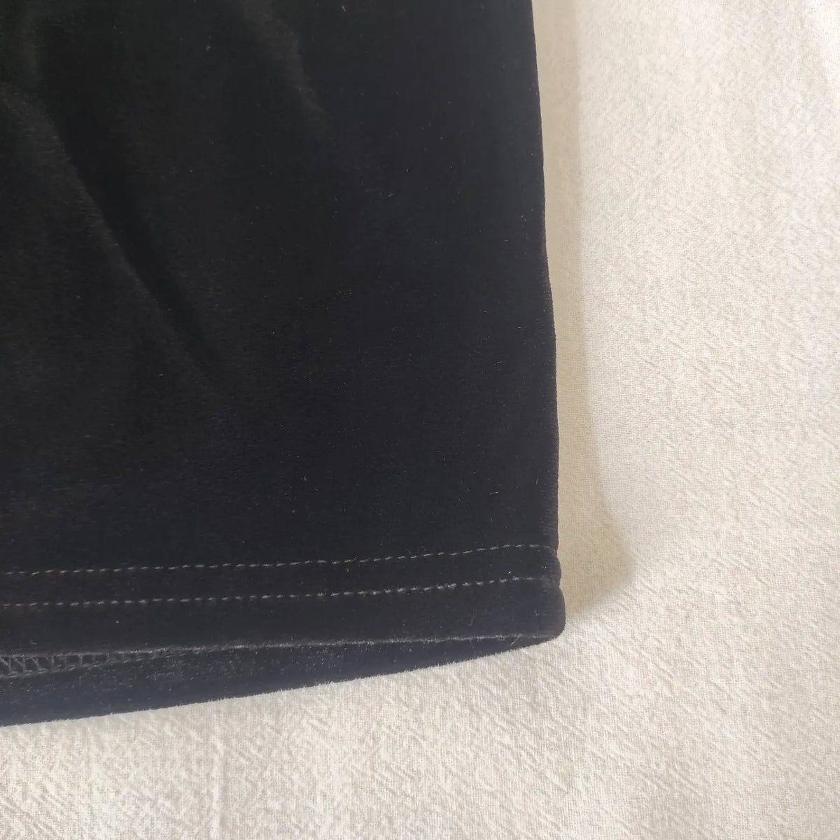 Close‑up side hem stitching detail black velvet halter crop top