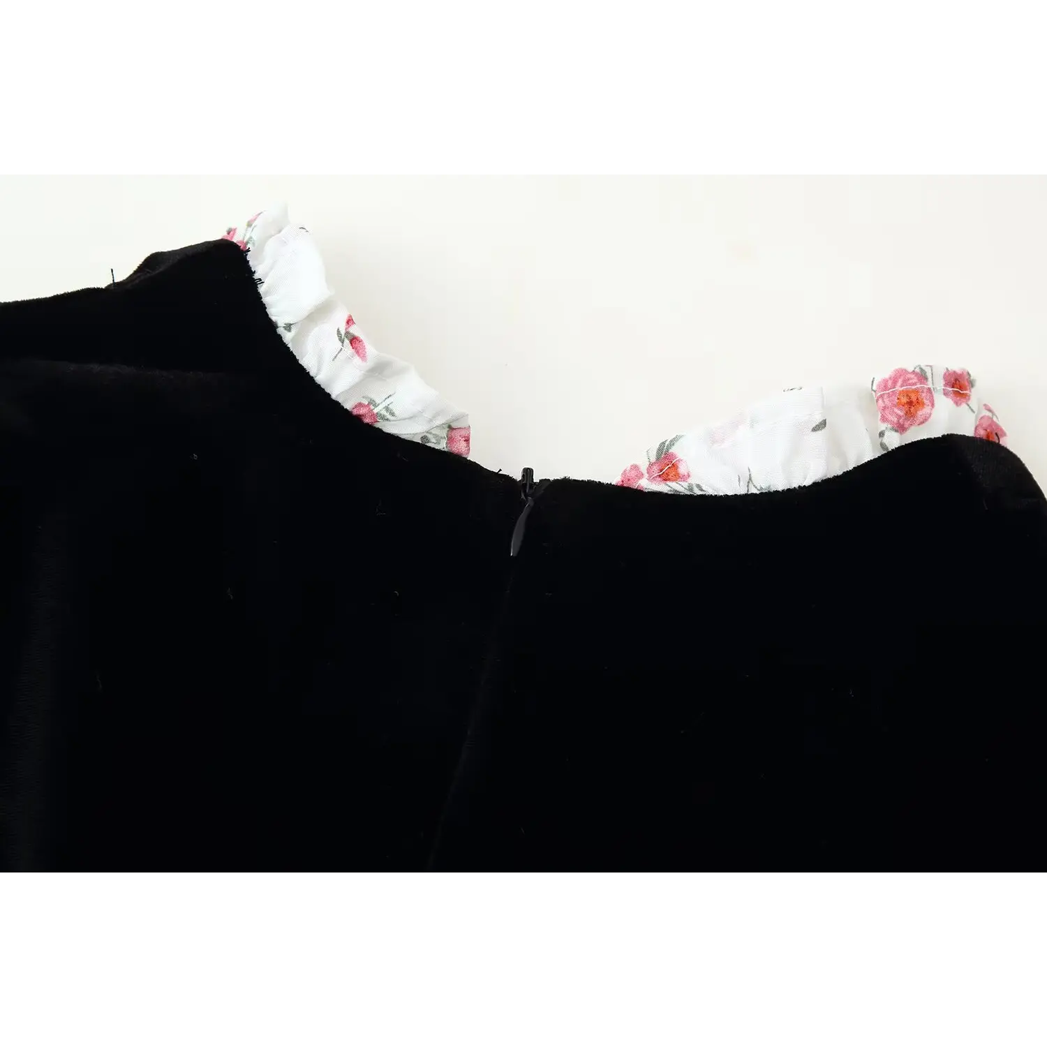 Close‑up of black velvet dress floral ruffle collar and back zipper closure, floral print trim detail