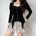 Model wearing black velvet floral layered mini dress, puff long sleeve with pearl buttons, tiered floral ruffle skirt, lifestyle fashion shot