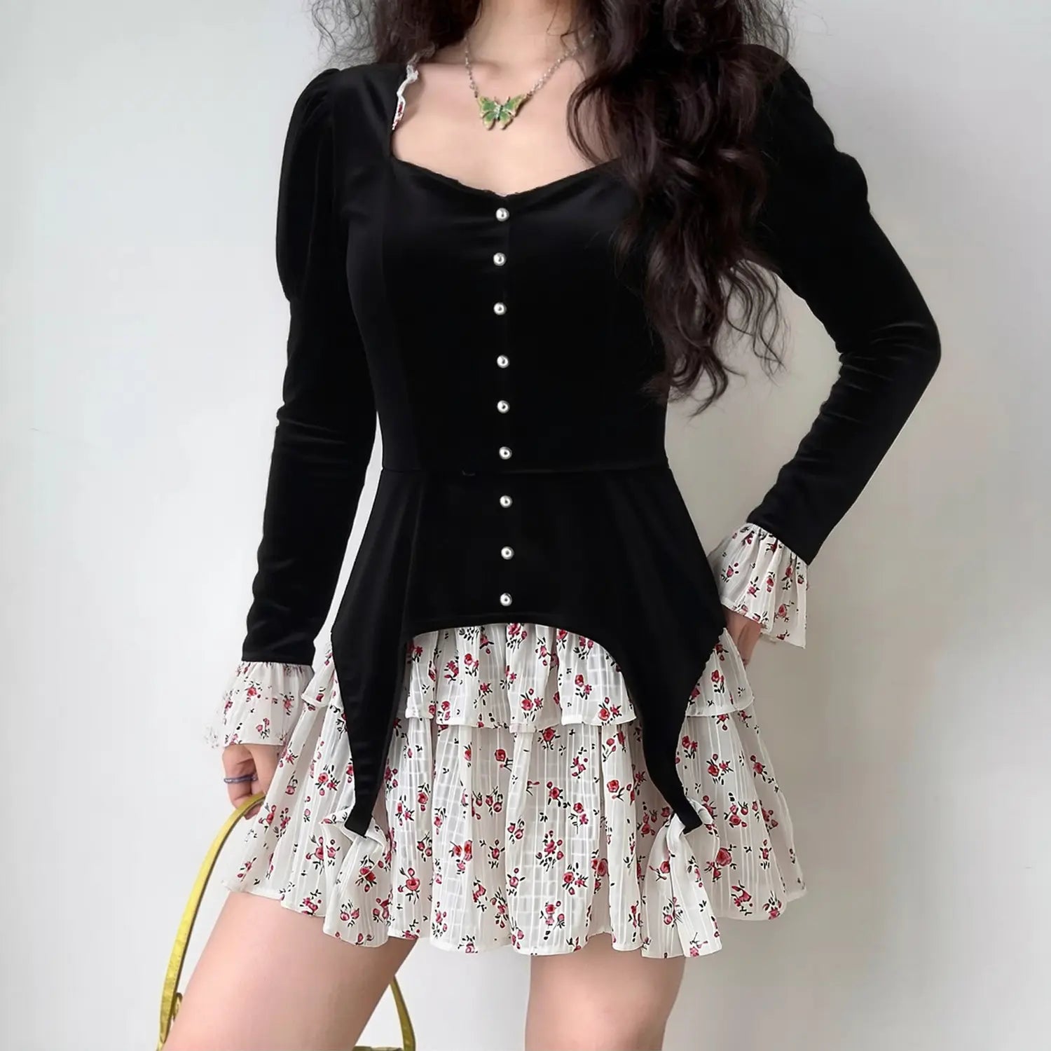 Model wearing black velvet floral layered mini dress, puff long sleeve with pearl buttons, tiered floral ruffle skirt, lifestyle fashion shot