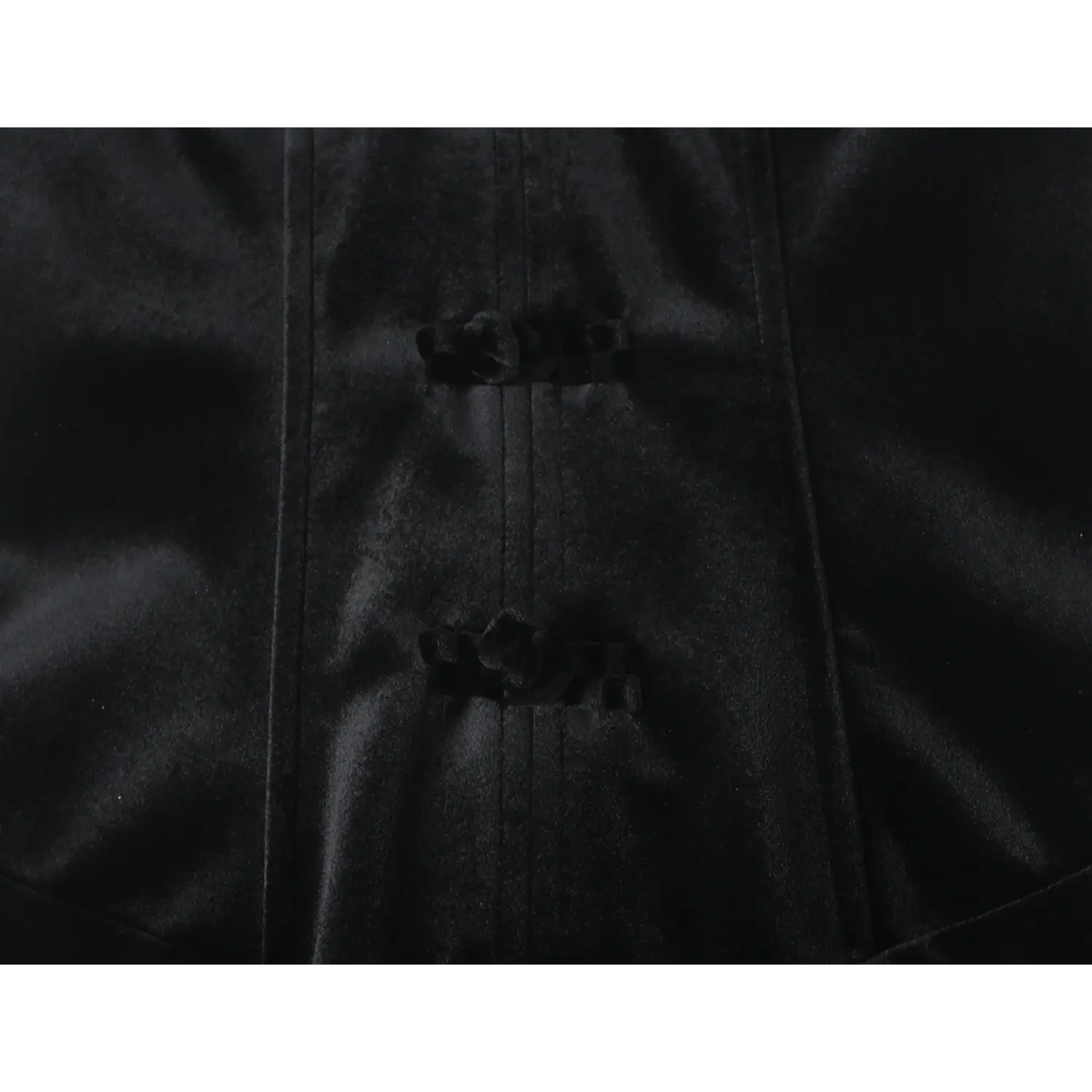 Close-up of black frog buttons on corset waist