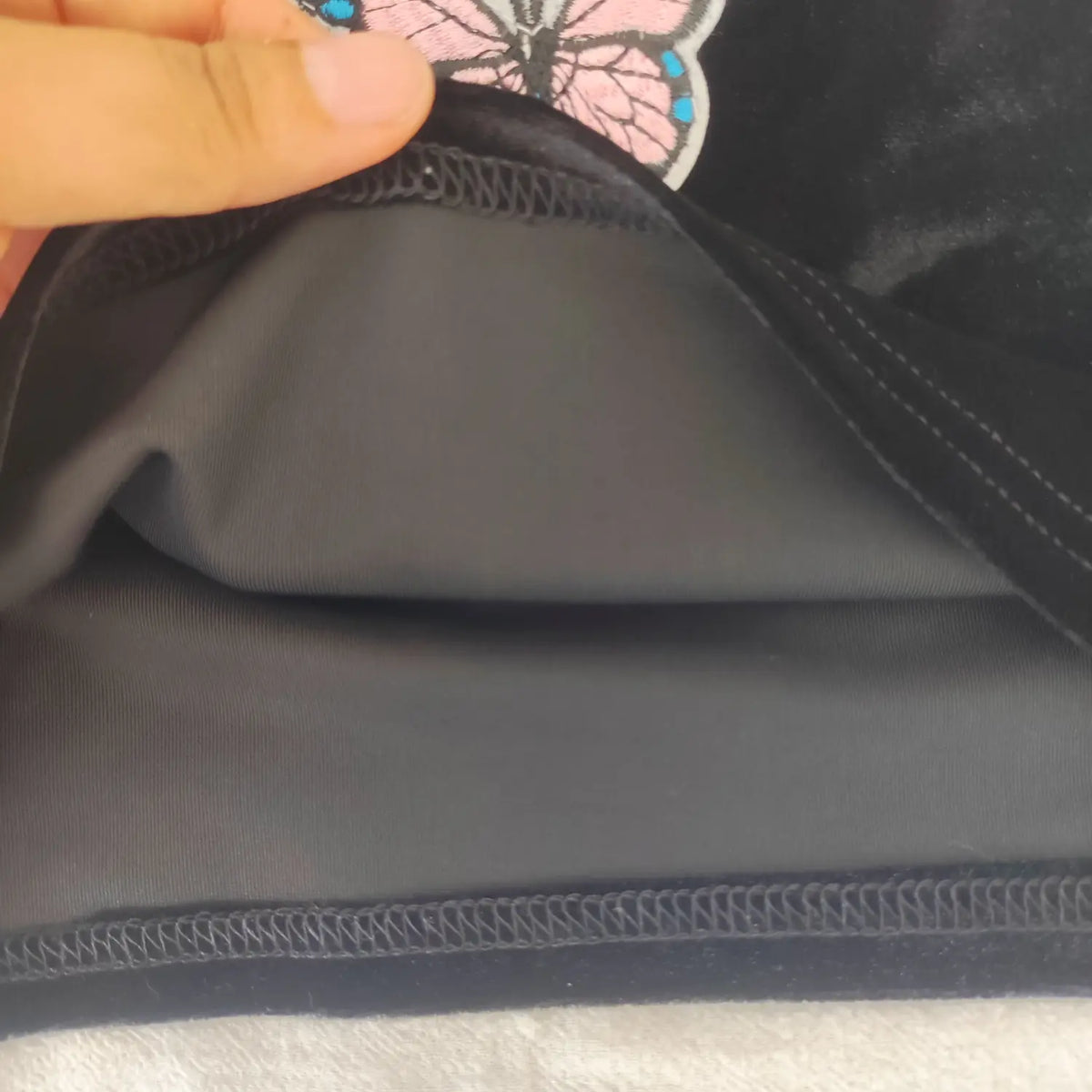 Close‑up inner lining and seam construction black velvet halter crop top