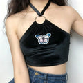 Model torso front close‑up black velvet halter crop top butterfly patch metal ring halter