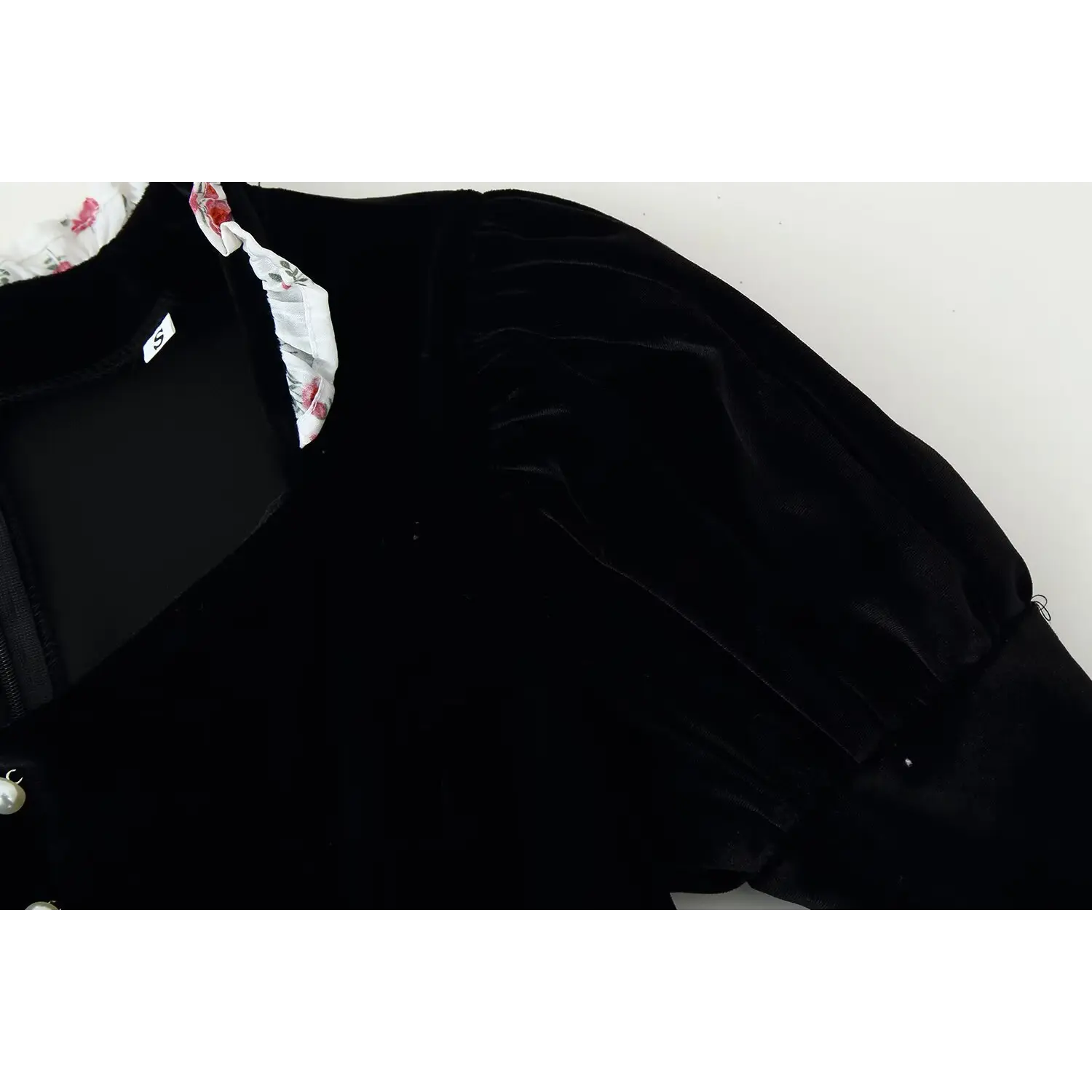Close‑up shot of black velvet puff long sleeve, show fabric texture and shoulder gathering detail