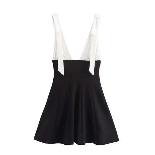 Full back view on white background of black and white bow-tie strap fit-and-flare mini dress