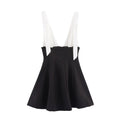 Full front view on white background of black and white bow-tie strap fit-and-flare mini dress