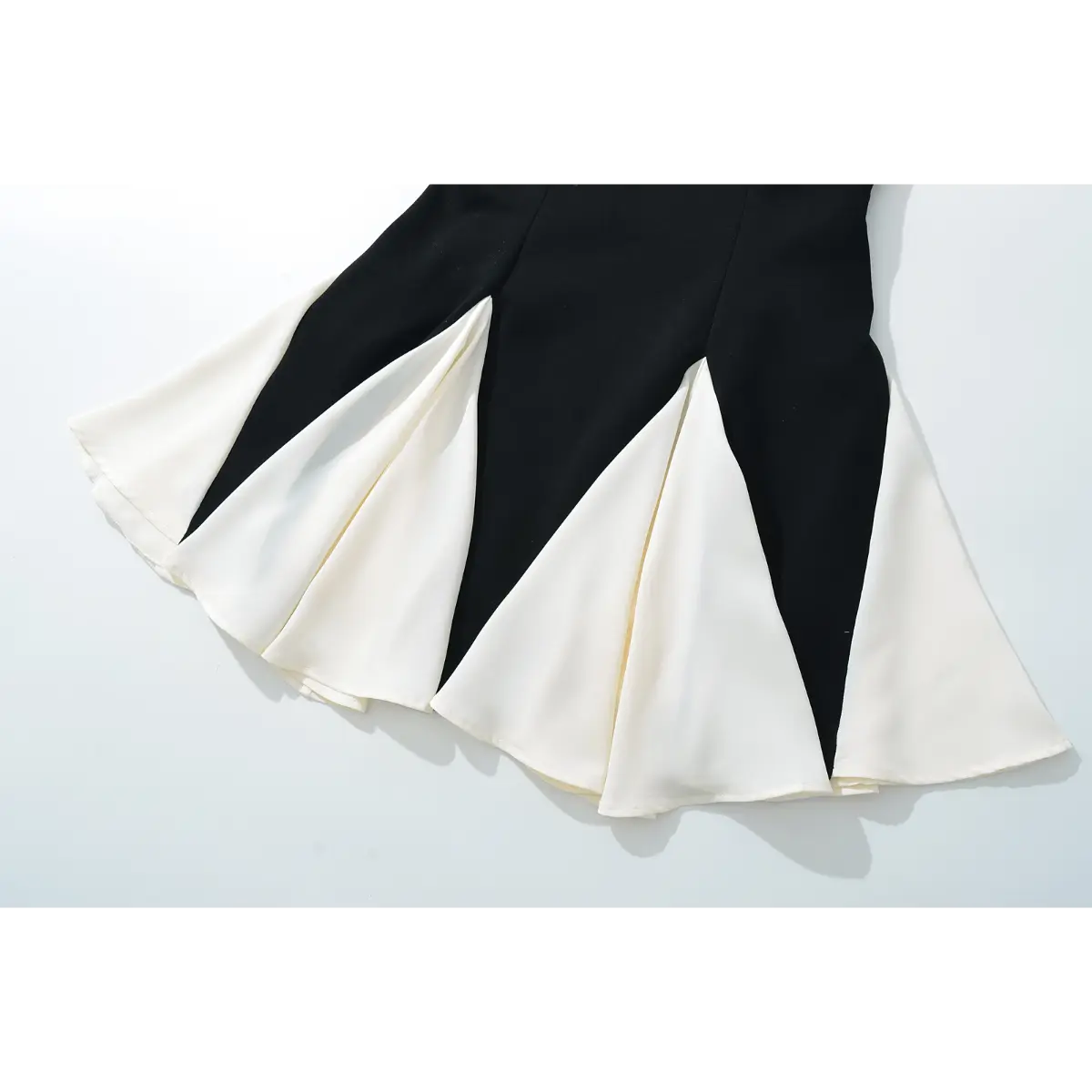 Full view of the flared skirt, showing the alternating black and white panels and hem construction.