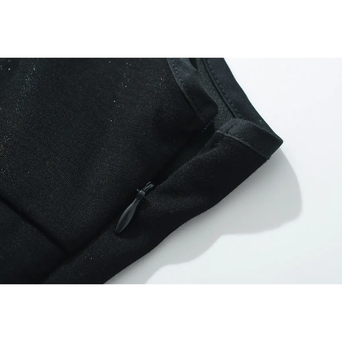 Close-up of the side zipper and finished seam on the black cami dress.