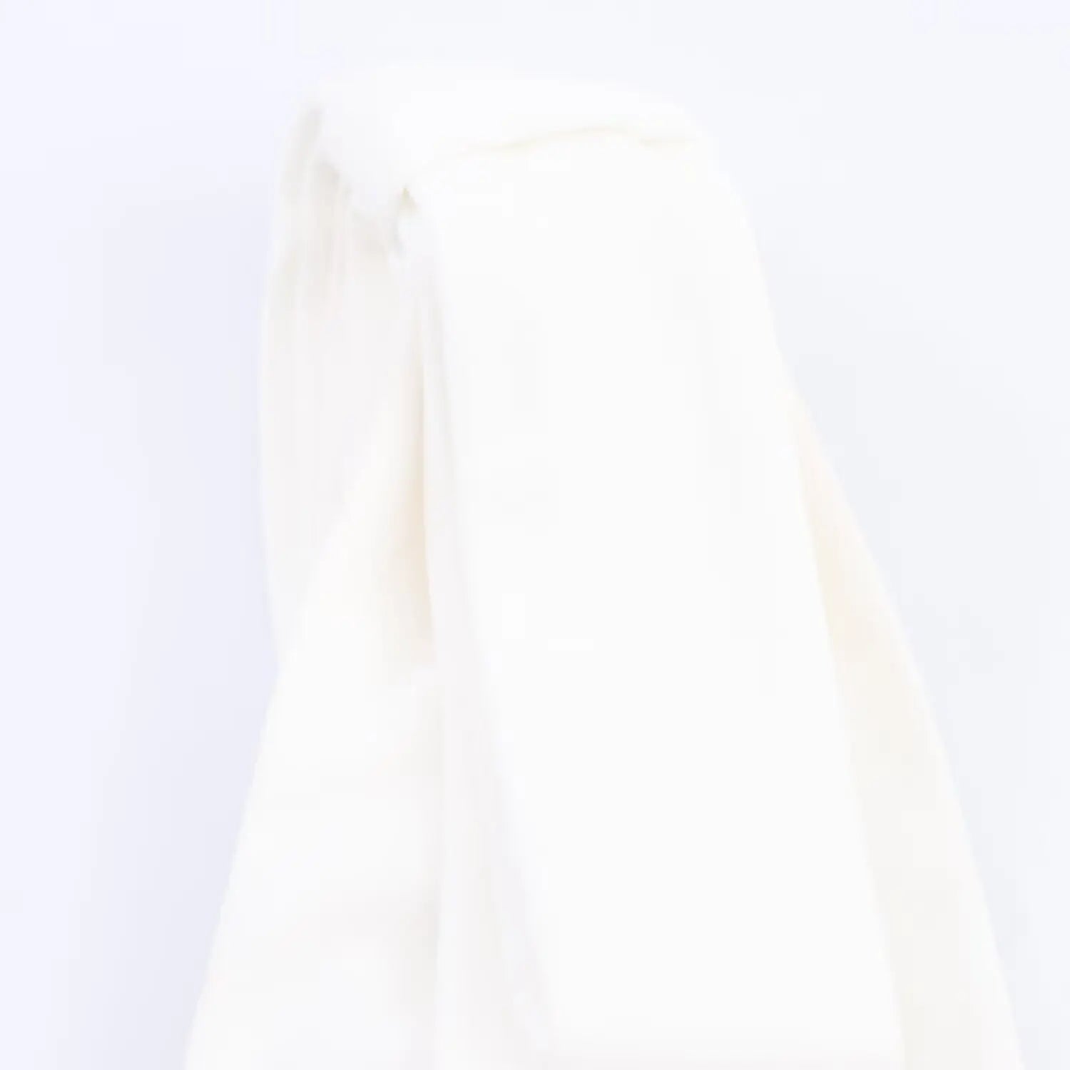 Macro shot of the smooth fabric texture on the white bow-tie shoulder strap