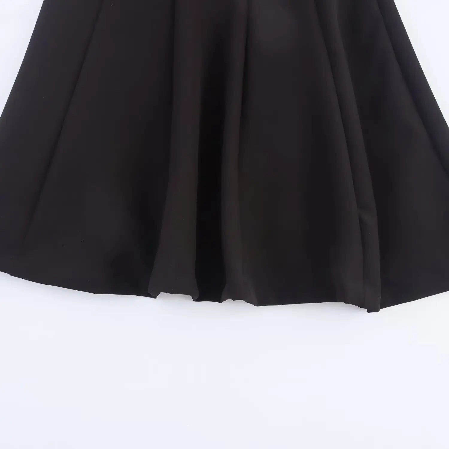 Close-up of the flared A-line skirt hem showing the structured panel stitching