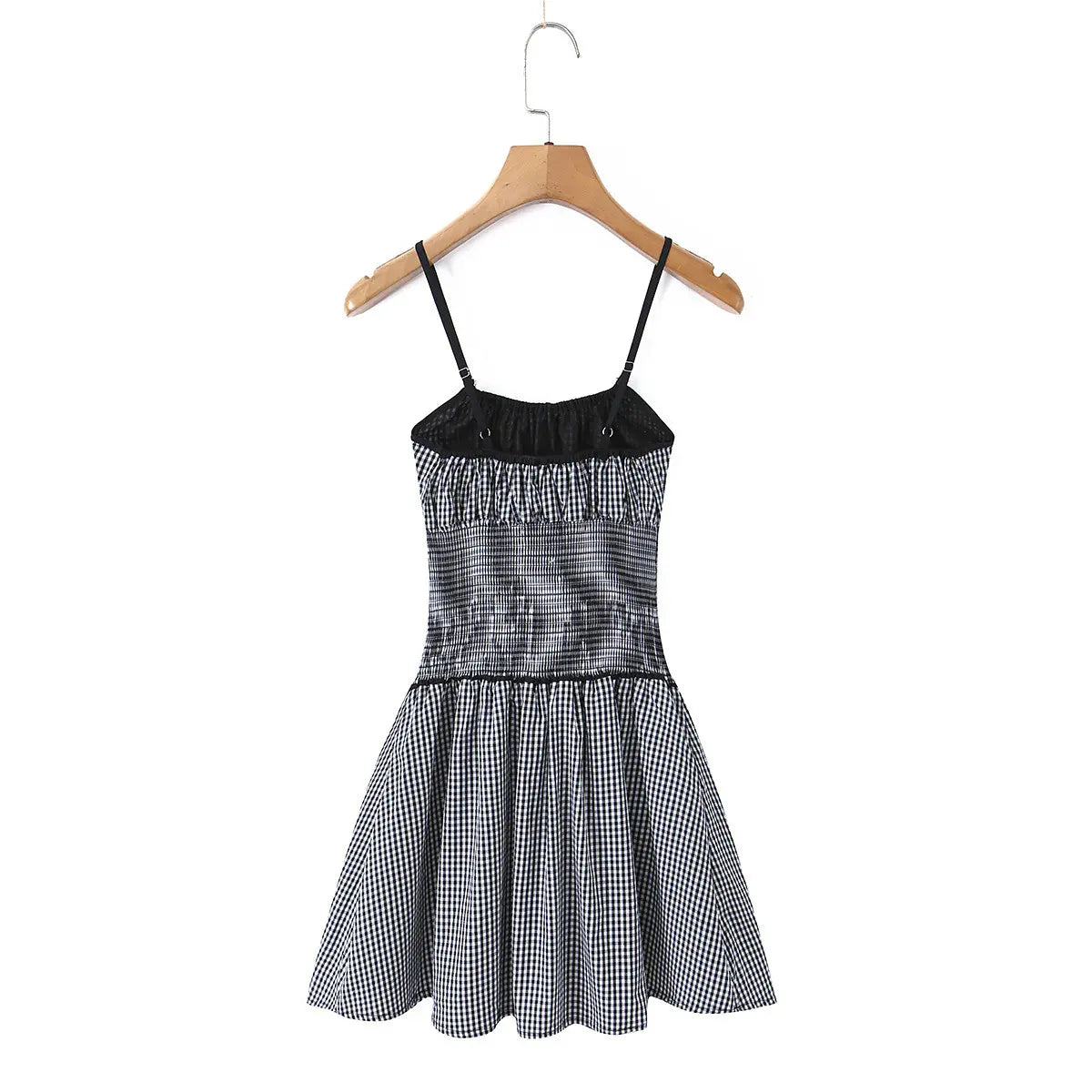 Full back view of the gingham cami dress on a wooden hanger, showing the inner lining and back design.