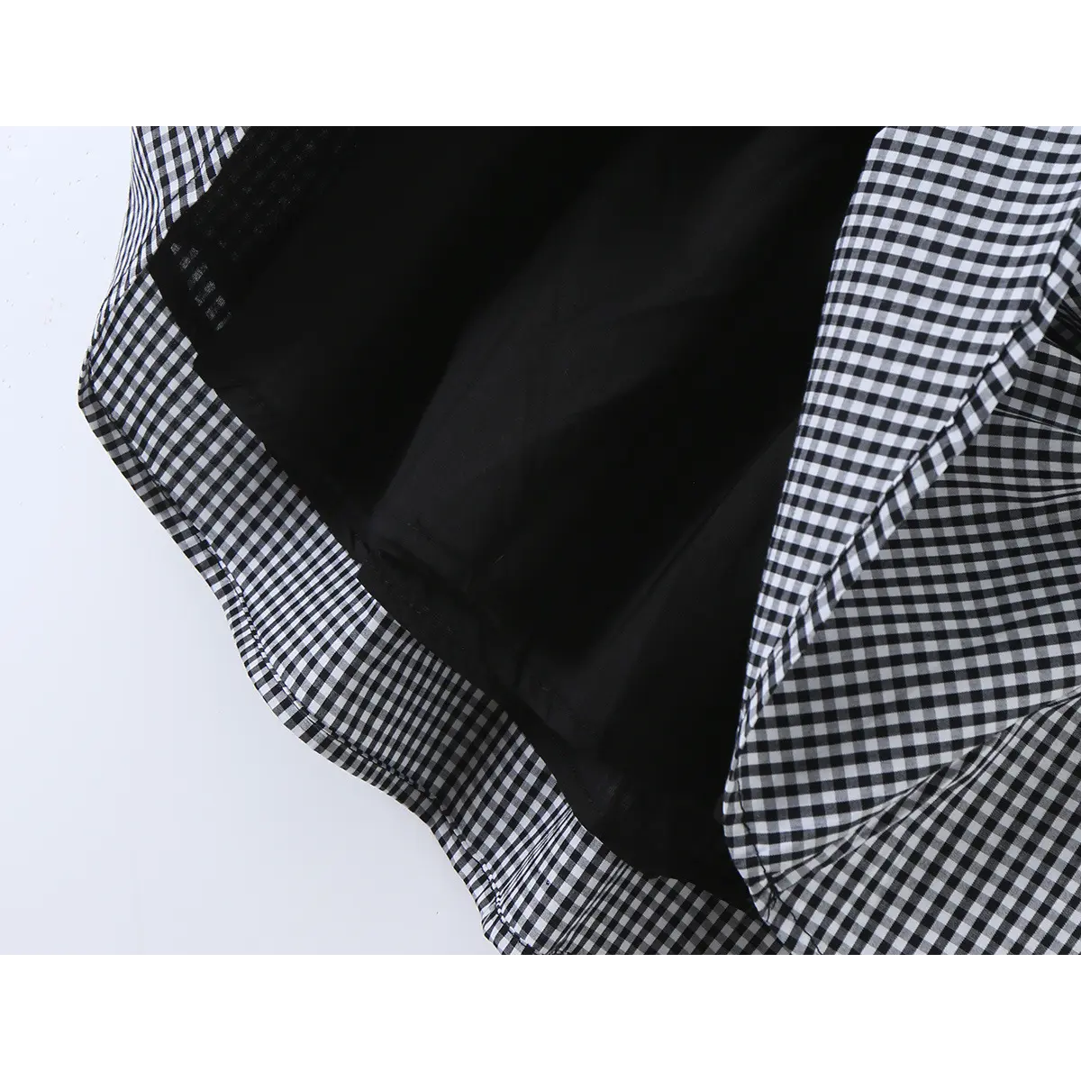 Close-up of the black inner lining and gingham fabric at the skirt hem.