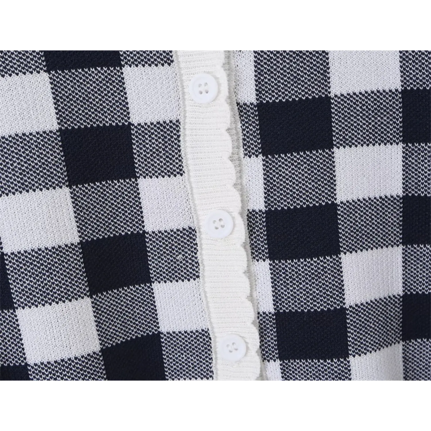Extreme closeup self-fabric white round buttons, neat topstitch scalloped binding edge, fine two-tone check knit fabric