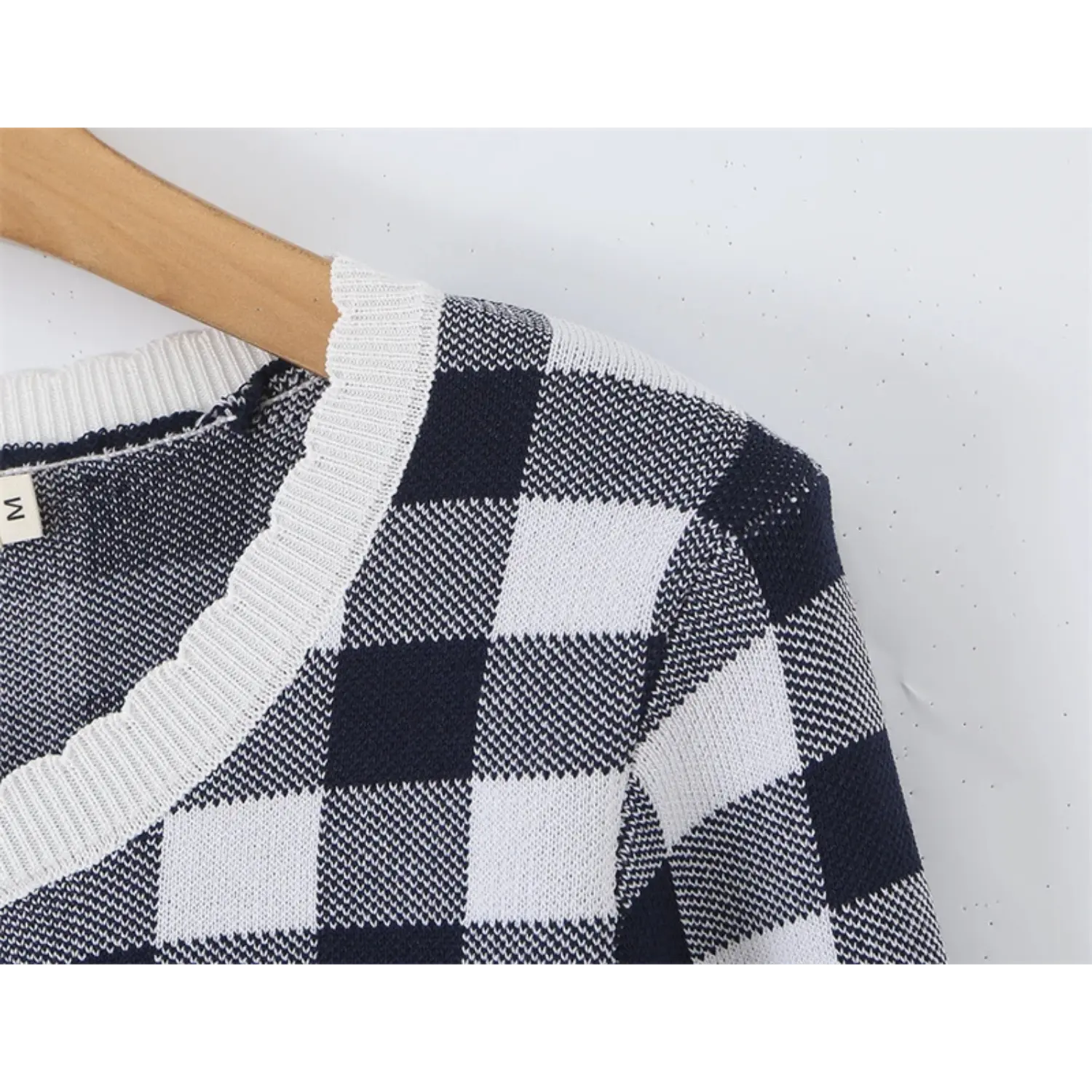 Partial shoulder ribbed scalloped neck trim closeup, tight stretch knit ribbing, uniform black and white square gingham weave