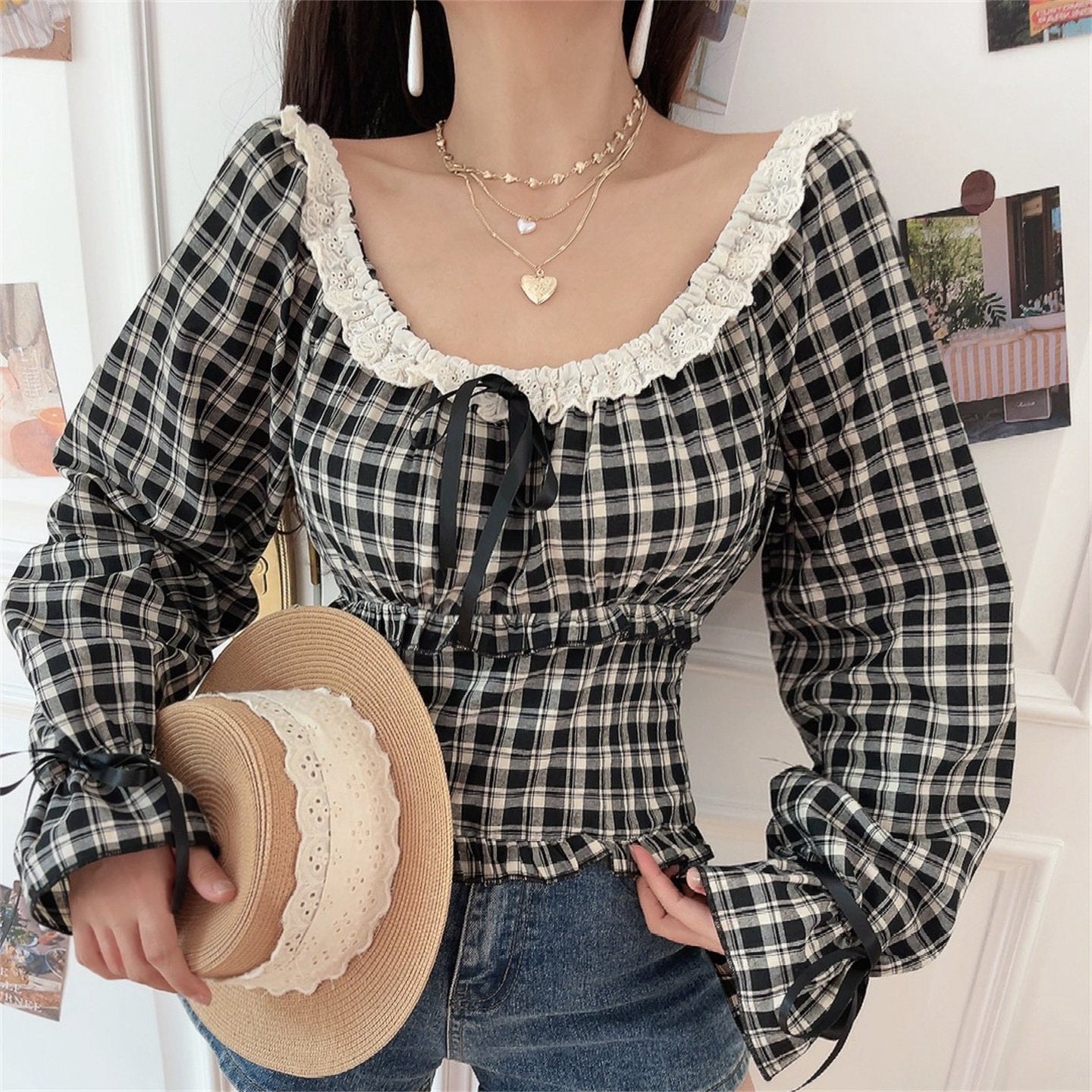 Black white gingham lace off shoulder crop top model front shot with straw hat, wavy eyelet lace cold shoulder neck front black ribbon drawstring elastic ruffle hem cuff tie flare long sleeve match denim shorts cottagecore sweet girl daily outfit display