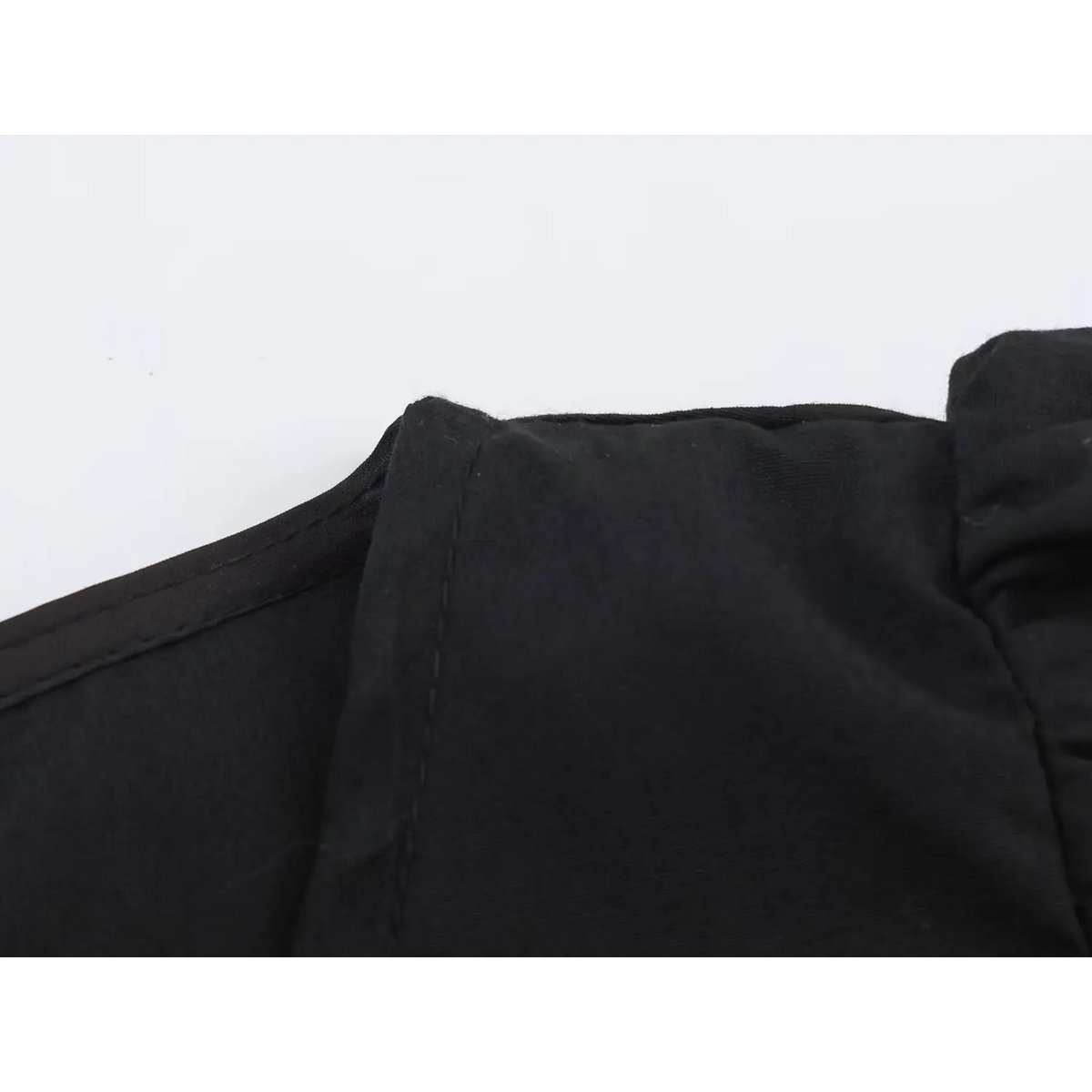 Close-up of black woven fabric with soft folds and clean stitching