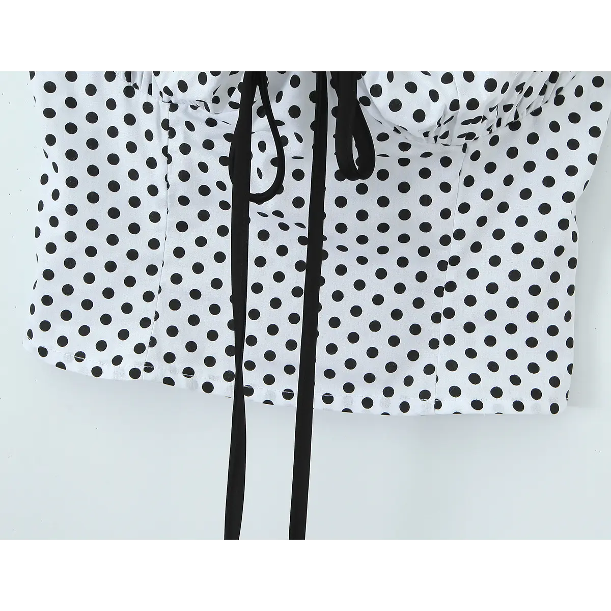 Close-up of the straight finished hem on the polka dot camisole.