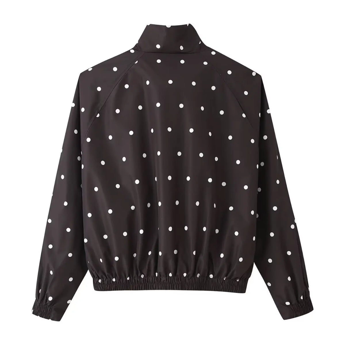 Back view of black cropped windbreaker with white polka dots, raglan sleeves, elastic hem, white background