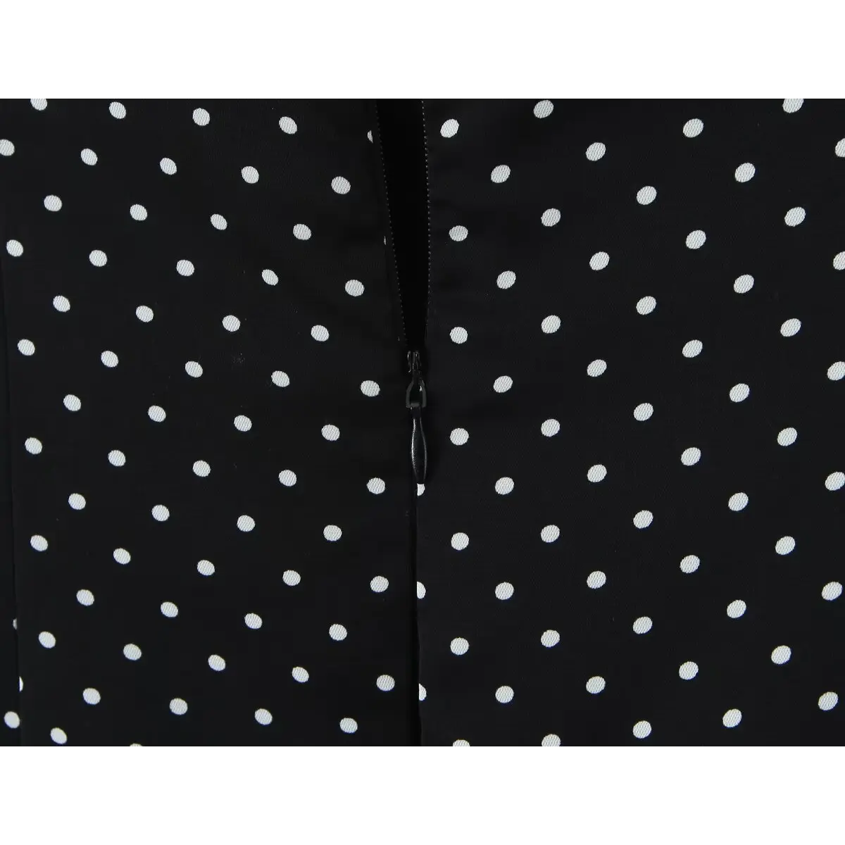 Close-up of the invisible back zipper on the polka dot fabric.